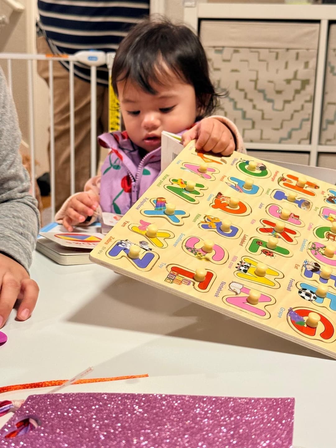 picture of a kid in a daycare learning how to color with a nanny caregiver