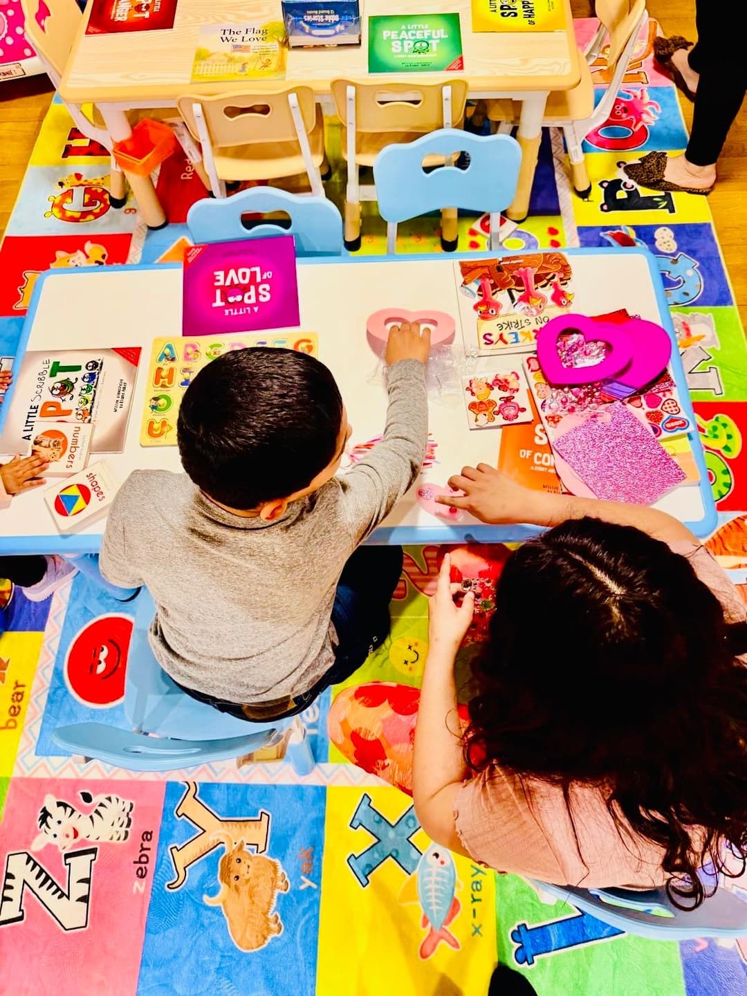 picture of kids in a daycare sitting together learning with an early childhood educator