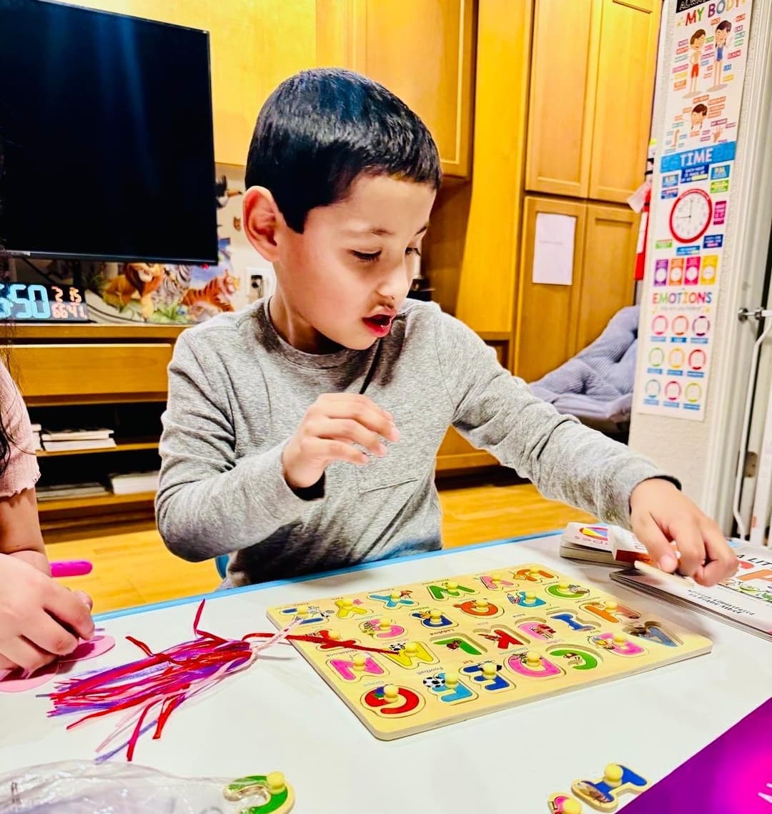 picture of kids in a daycare sitting together learning with an early childhood educator