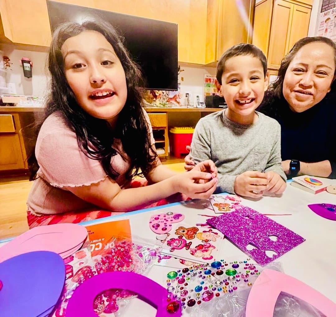 picture of kids in a daycare sitting together learning with an early childhood educator